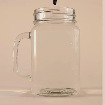 Short video showing a drop of VitaBlue Methylene Blue falling into a clear glass jar of water, demonstrating its vibrant blue dispersion on a beige background
