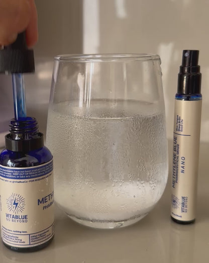 Close-up video of VitaBlue Methylene Blue bottle, Nano spray, and a glass of water showing blue liquid being drawn into the dropper